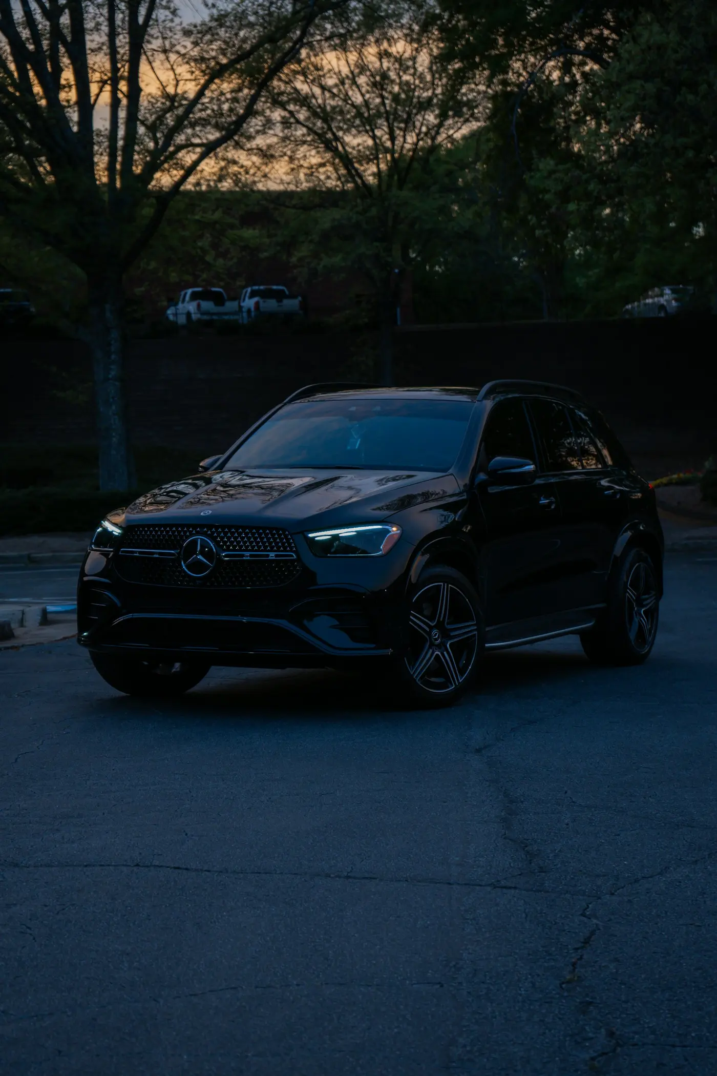 Black SUV of a protective fleet at dusk